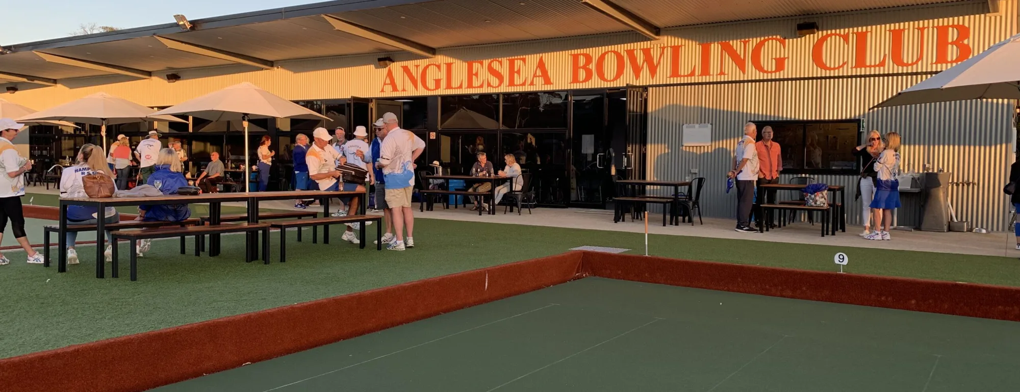 The crowd outside the Anglesea Bowling Club clubhouse on a sunny afternoon